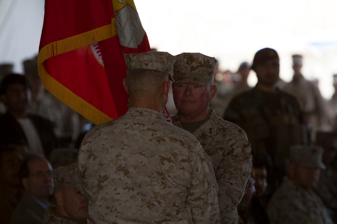 U.S. Marine Corps Maj. Gen. Walter L. Miller Jr, right, accepts the Regional Command-Southwest colors to assume command of RC-SW from Maj. Gen. Charles M. Gurganus during the transfer of authority ceremony to II MEF (FWD) at Camp Leatherneck, Helmand province, Afghanistan, Feb. 28, 2013. Miller is the commanding general of II MEF (FWD). The I MEF (FWD) redployed back to Camp Pendleton, Calif., after a year of fighting the insurgency and transitioning the fight to Afghan-led operations. (U.S. Army photo by Bill Putnam/Released)