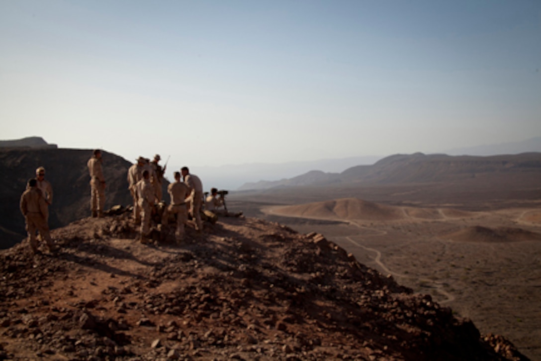 U.S. Marines with the Close Air Support (CAS) teams, ANGLICO Co., 15th Marine Expeditionary Unit (MEU), establish an observation position to control indirect fire missions for aerial operations on Djibouti training impact area AR-11, Djibouti, February 11, 2013.  The 15th MEU is conducting sustainment training on various ranges throughout the host nation in preparation for any real world crisis.  (U.S. Marine Corps photo by: Master Sgt John A. Lee, II. / Not Released)