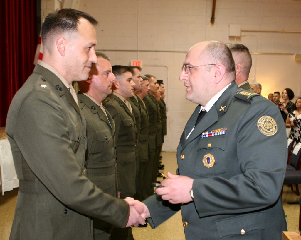 Republic of Georgia Col. Lasha Beridze, Deputy Chief of Defense, Georgian Armed Forces, awards Marine Lt. Col. Christopher Phelps, a security cooperation and GDP-ISAF lead planner, U.S. Marine Corps Forces, Europe, with General Giorgi Mazniashvili Medal during an award ceremony aboard Joint Expeditionary Base Little Creek – Fort Story in Virginia Beach, Va., Feb. 28. The General Giorgi Mazniashvili Medal is the fourth highest individual award in the Georgian Armed Forces and it honors a servicemember’s leadership and contributions to Georgian national defense. Phelps is a native of Silver Lake, Kan. 