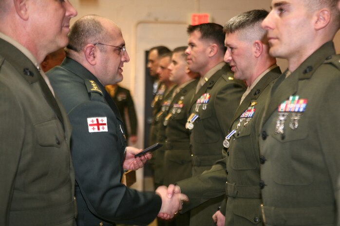 Republic of Georgia Col. Lasha Beridze, Deputy Chief of Defense, Georgian Armed Forces, awards Marine Capt. Jared Perry, communications officer, Georgia Liaison Team, with Republic of Georgia’s Peacekeeping Operations Medal, during an award ceremony aboard Joint Expeditionary Base Little Creek – Fort Story in Virginia Beach, Va., Feb. 28. The Republic of Georgia’s Peacekeeping Operations Medal is presented in recognition of a servicemember’s significant contributions to Georgian Armed Forces peacekeeping and combat operations.