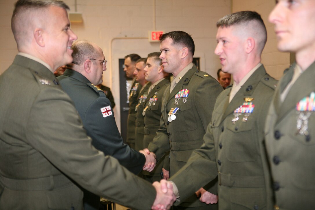 Republic of Georgia Col. Lasha Beridze, Deputy Chief of Defense, Georgian Armed Forces, awards Marine Maj. Matthew O'Donnell, officer-in-charge, Georgia Liaison Team, with General Giorgi Mazniashvili Medal and the Republic of Georgia’s Peacekeeping Operations Medal during an award ceremony aboard Joint Expeditionary Base Little Creek – Fort Story in Virginia Beach, Va., Feb. 28. The General Giorgi Mazniashvili Medal is the fourth highest individual award in the Georgian Armed Forces and it honors a servicemember’s leadership and contributions to Georgian national defense.