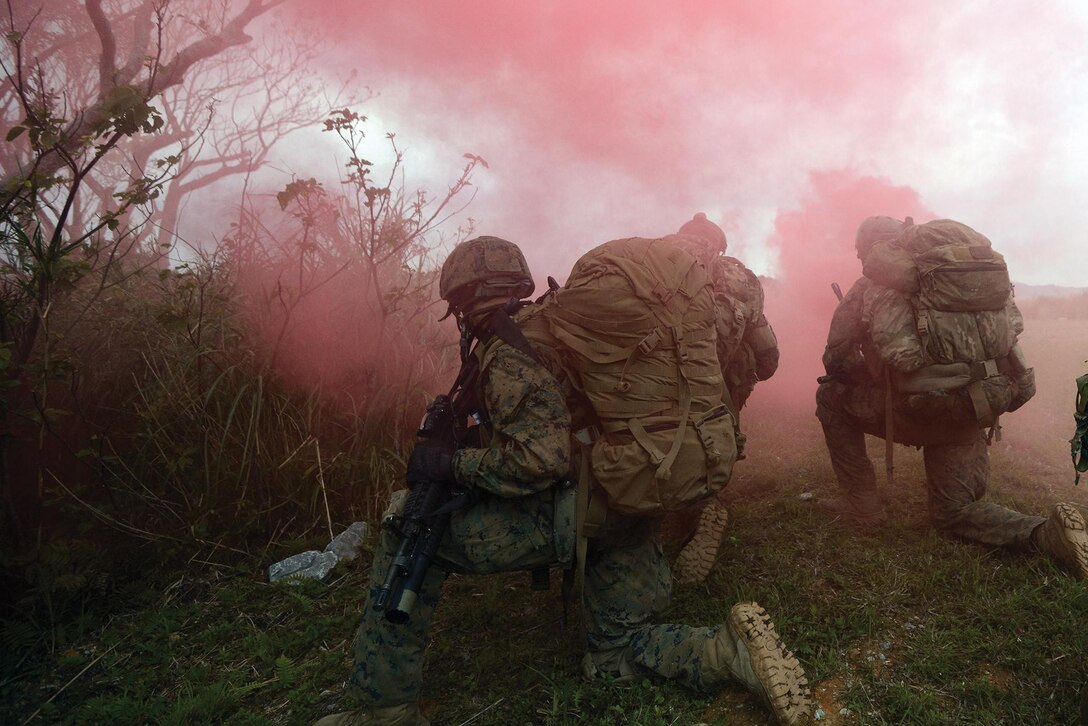 Marines with 3rd Reconnaissance Battalion mark their extraction site with red smoke Feb. 21 following the conclusion of a patrol at the Jungle Warfare Training Center on Camp Gonsalves. The MV-22B Osprey aircrew used the smoke to locate the landing zone and extract the Marines. 