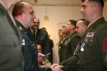 Republic of Georgia Col. Lasha Beridze, Deputy Chief of Defense, Georgian Armed Forces, awards Marine Gunnery Sgt. Corey Brown, intelligence chief, Georgia Liaison Team, with Republic of Georgia’s Peacekeeping Operations Medal, during an award ceremony aboard Joint Expeditionary Base Little Creek – Fort Story in Virginia Beach, Va., Feb. 28. The Republic of Georgia’s Peacekeeping Operations Medal is presented in recognition of a servicemember’s significant contributions to Georgian Armed Forces peacekeeping and combat operations.