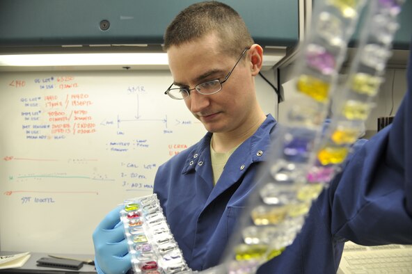 WHITEMAN AIR FORCE BASE, Mo. -- Staff Sgt. Nathan Knox, 509th Medical Group Medical Laboratory Scientists, looks at cuvettes, Feb. 20. The cuvettes are examined by a chemistry analyzer to determine what the person test value is based off color changes. The test value of a person can range from problems cholesterol, urinary tract infection, diabetes or many others illnesses. (U.S. Air Force photo by Airman 1st Class Keenan Berry) (Released)


