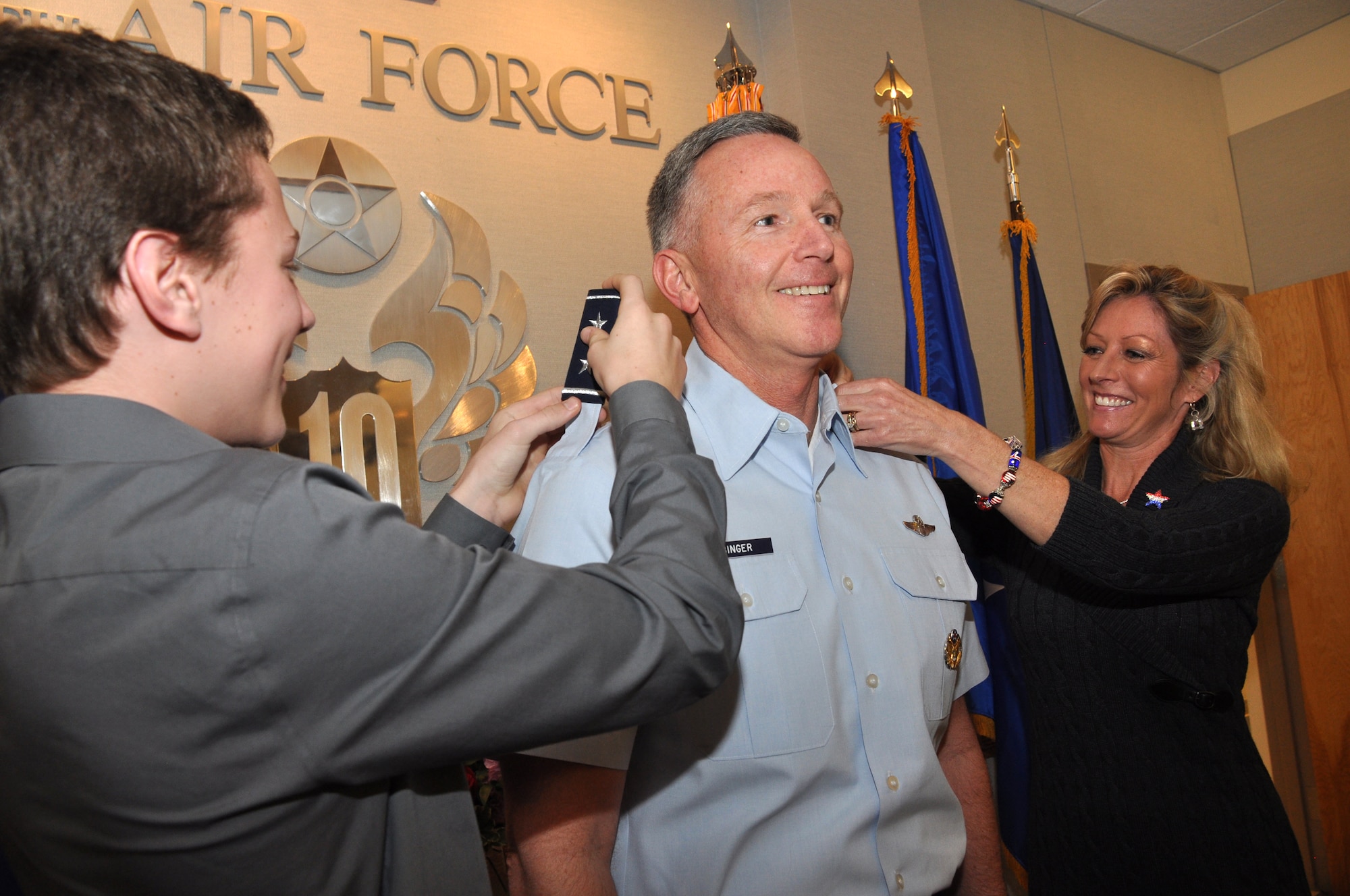 Tenth Air Force Commander Bill Binger pinned on his second star during a small ceremony at the Naval Air Station Fort Worth Joint Reserve Base, Texas, Feb. 2. Changing his shoulder boards were his son, to his left, and his wife, on his right. Maj. Gen Kevin Pottinger, Mobilization Assistant to the Vice Commander, Pacific Air Forces, Joint Base Pearl Harbor-Hickam, Hawaii. was the officiating officer. (U.S. Air Force photo/Master Sgt. Julie Briden-Garcia)