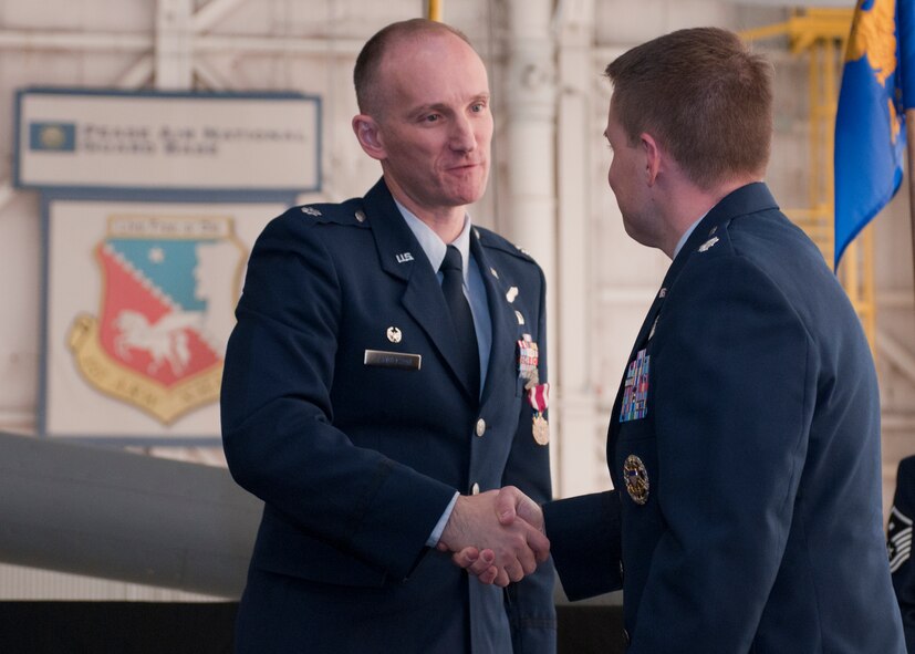 Lt. Col. Ryan R. Samuelson (left) congratulates Lt. Col. J. Scot Heathman on Heathman's assumption of command of the 64th Air Refueling Squadron, Pease Air National Guard Base, N.H., February 28, 2013.  Sameulson is the relenquishing commander of the 64th ARS. (National Guard photo by Walter Santos/Released)