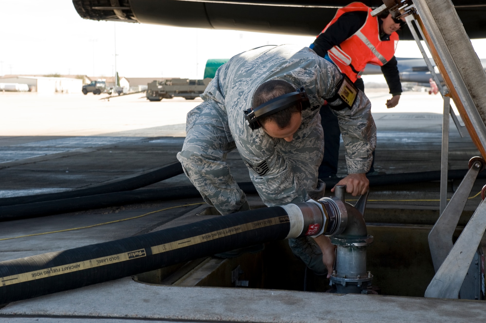 Tech. Sgt. Marco Navarro, 7th Logistics Readiness Squadron, attaches a fuel hose to fuel a B-1 Bomber while performing a hot pit refuel Feb. 22, 2013, at Dyess Air Force Base, Texas. New to the B-1 Bomber, hot pit refueling is a procedure used to rapidly refuel the aircraft while their engines are running, resulting in a speedy refuel. (U.S. Air Force photo by Airman 1st Class Jonathan Stefanko/ Released)