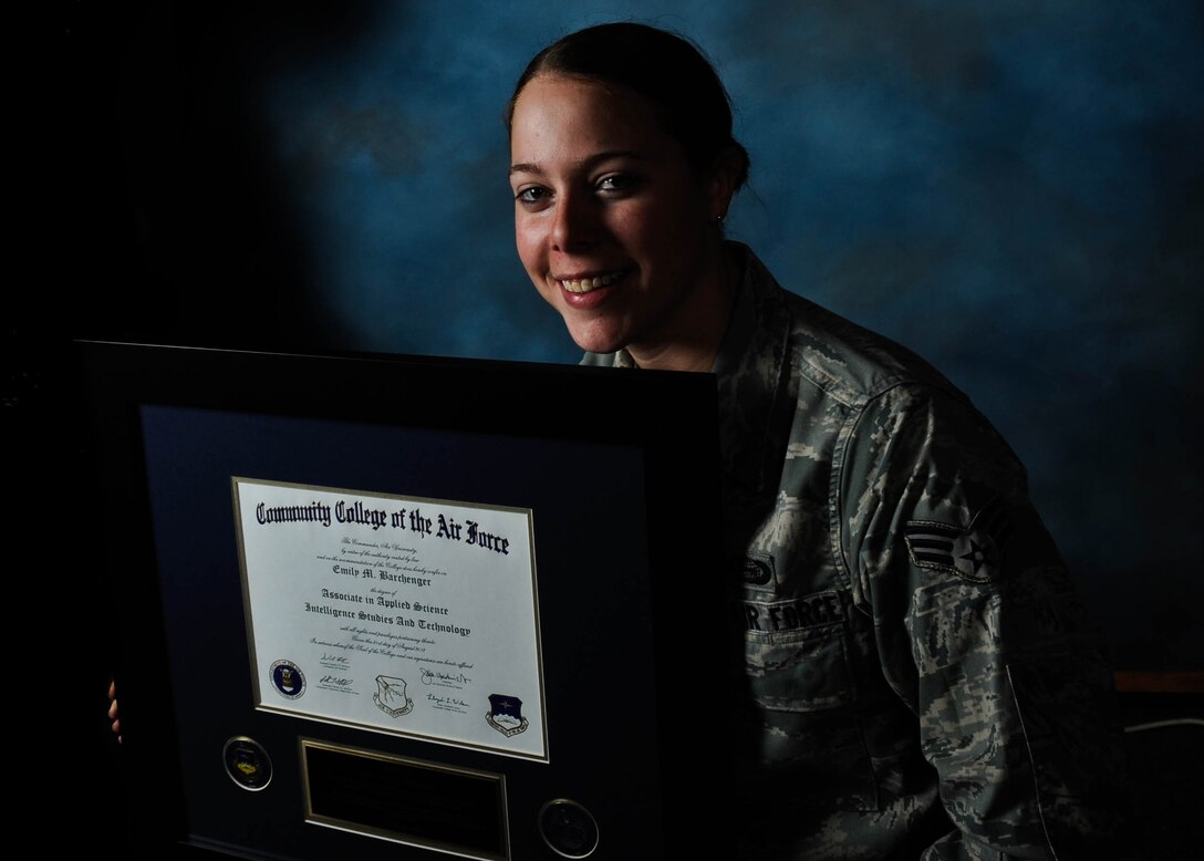 Senior Airman Emily Barchenger, 37th Bomb Squadron intelligence analyst, displays her Community College of the Air Force Associates Degree of Science in Intelligence Studies and Technology at Ellsworth Air Force Base, S.D., Feb. 25, 2013. Barchenger completed her degree requirements while deployed to the 379th Air Expeditionary Wing in Southwest Asia. (U.S. Air Force photo by Airman 1st Class Zachary Hada/Released)