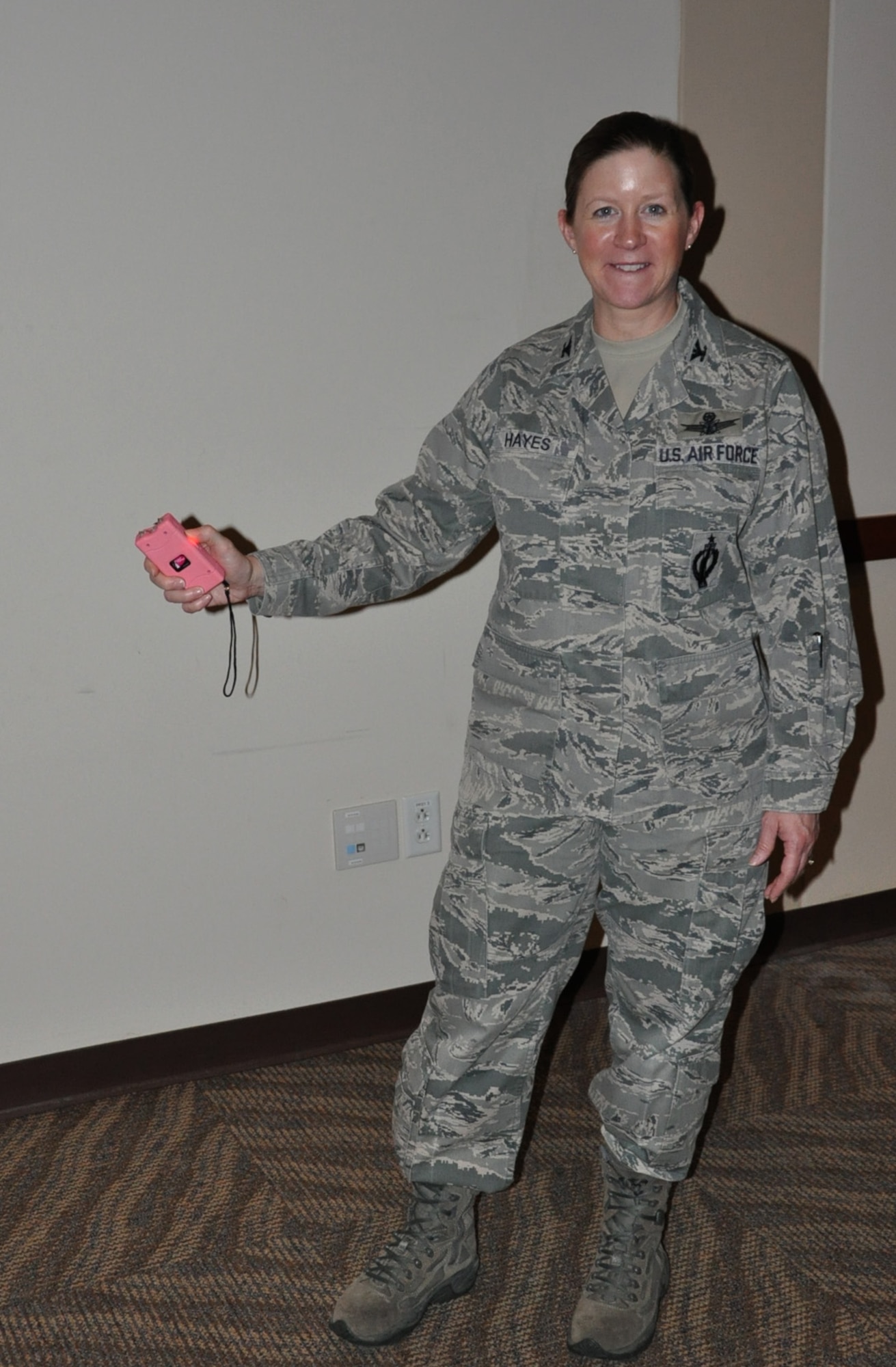 Col. Tracey Hayes, 460th Space Wing vice commander, tests a stun gun during the Ladies’ Empowerment Social and Book Club event Feb. 27, 2013, at the Leadership Development Center, Buckley Air Force Base, Colo. Approximately 40 women attended the social, which was part one of a two-part series about self defense.  Attendees were able to view and handle self-defense products such as stun guns, pepper spray and various travel security items. (U.S. Air Force photo by Staff Sgt. Kali L. Gradishar/Released)