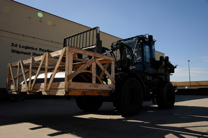 Senior Airman Jeffrey Dean, 2nd Logistics Readiness Squadron Vehicle Operations, lowers a B-52H engine cowling into the 2 LRS Shipping and Distribution yard prior to shipping on Barksdale Air Force Base, La., Feb. 28. The Vehicle Ops section helps further Barksdale's mission of delivering precision munitions to the battlefield by providing transportation for aircrew and shipping and receiving parts for aircraft. (U.S. Air Force photo/Airman 1st Class Andrew Moua)
