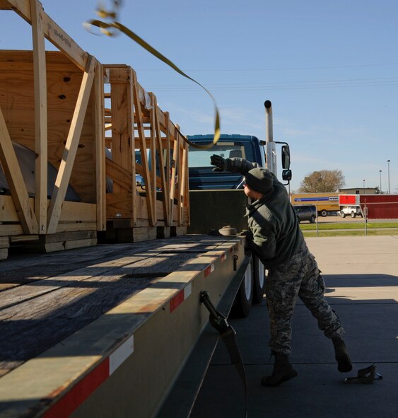 Senior Airman Jesse Bowers, 2nd Logistics Readiness Squadron Vehicle Operations, unhooks a tow strap to unload B-52H Stratofortress cowlings on Barksdale Air Force Base, La., Feb. 28. The cowlings will be shipped to Tinker Air Force Base, Okla., for depot level repairs. Depot level repairs are where components or aircraft parts require higher level maintenance and need more advanced equipment to help assess problems. (U.S. Air Force photo/Airman 1st Class Andrew Moua)