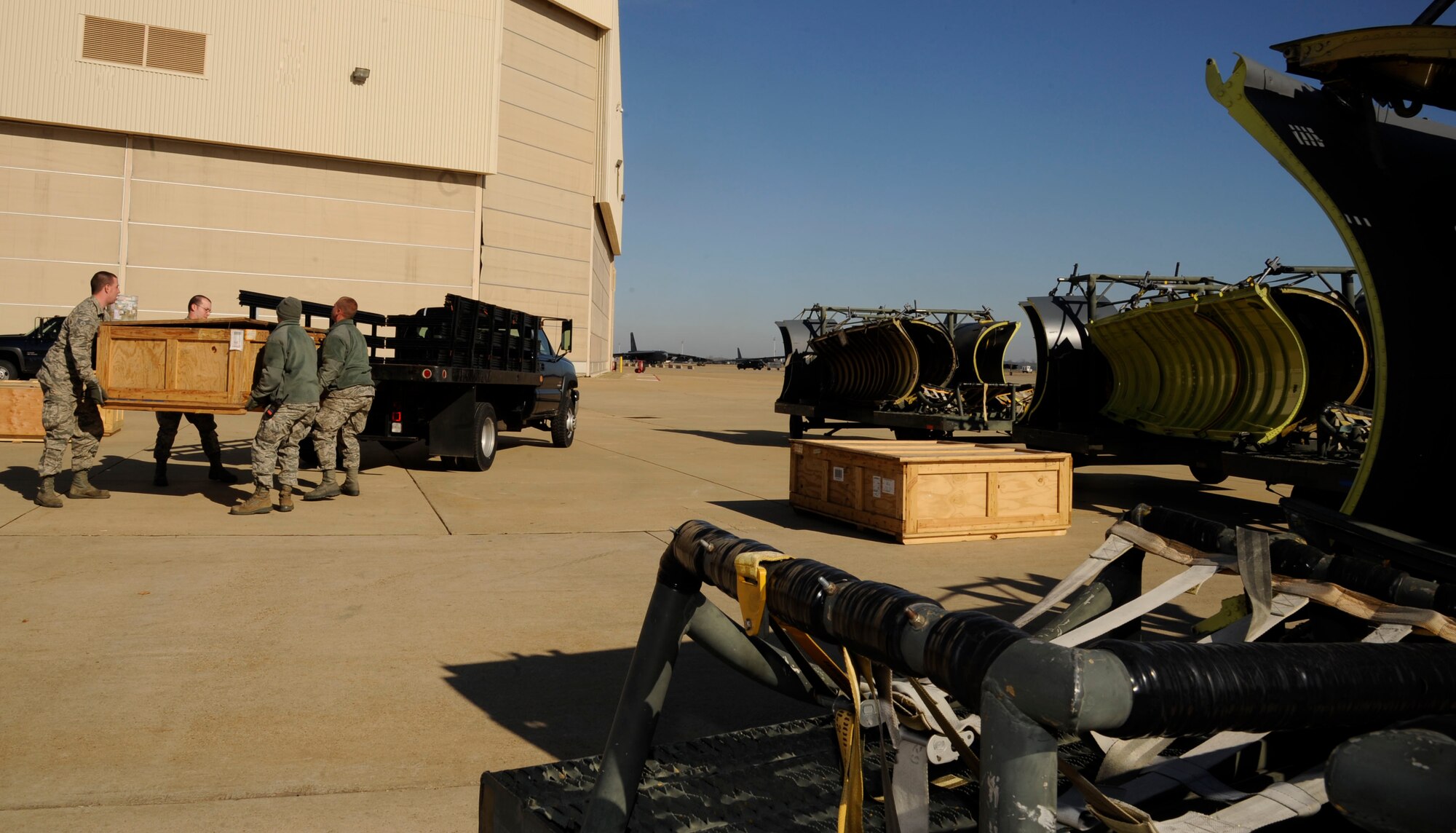 Airmen assigned to the 2nd Logistics Readiness Squadron Vehicle Operations section, load aircraft cowlings onto a vehicle for transport on Barksdale Air Force Base, La., Feb. 28. The Airmen packed and loaded 14 cowlings for shipment to Tinker Air Force Base, Okla., for repairs. (U.S. Air Force photo/Airman 1st Class Andrew Moua)
