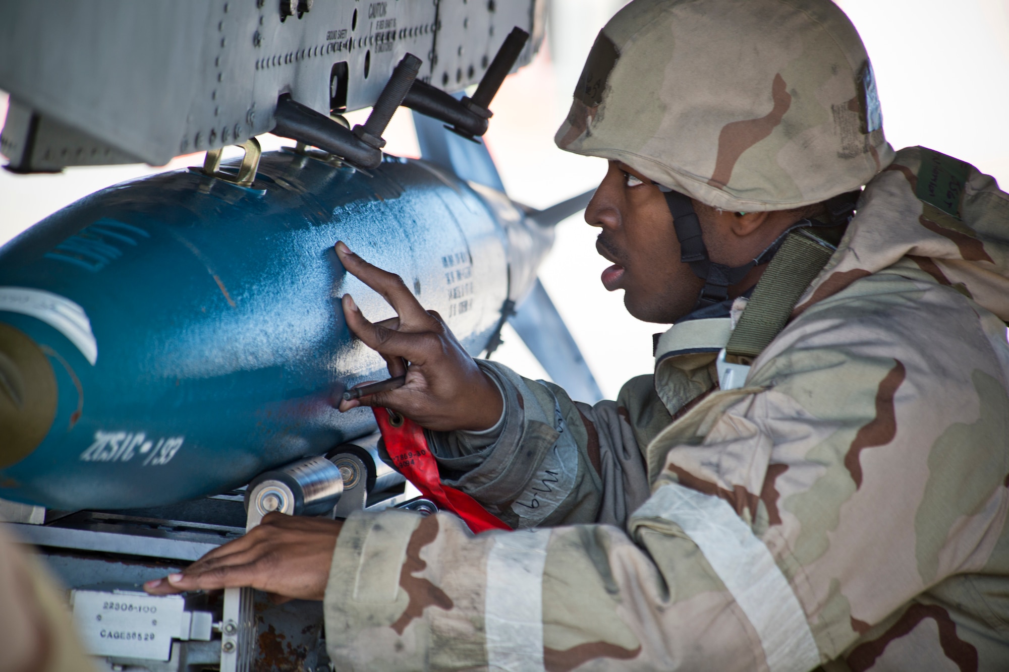 U.S. Air Force Staff Sgt. Harrison Ragin, 23d Mission Operations Squadron weapons load crew member, helps load a BDU-50 practice bomb to an A-10C Thunderbolt II during a phase II operational readiness exercise Feb. 28, 2013, at Moody Air Force Base, Ga. Ragin was responsible for ensuring safe and proper weapon loads to the aircraft. (U.S. Air Force photo by Staff Sgt. Jamal D. Sutter/Released)  