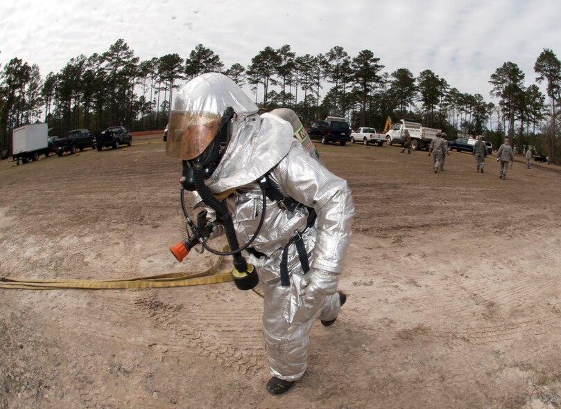 A 23d Civil Engineer Squadron firefighter sprints to a tent to help extinguish a fire during a phase II operational readiness exercise Feb. 27, 2013, at Moody Air Force Base, Ga. Throughout the exercise, firefighters were evaluated on how fast and accurately they could put out fires. (U.S. Air Force Photo by Airman Paul Francis/Released)
