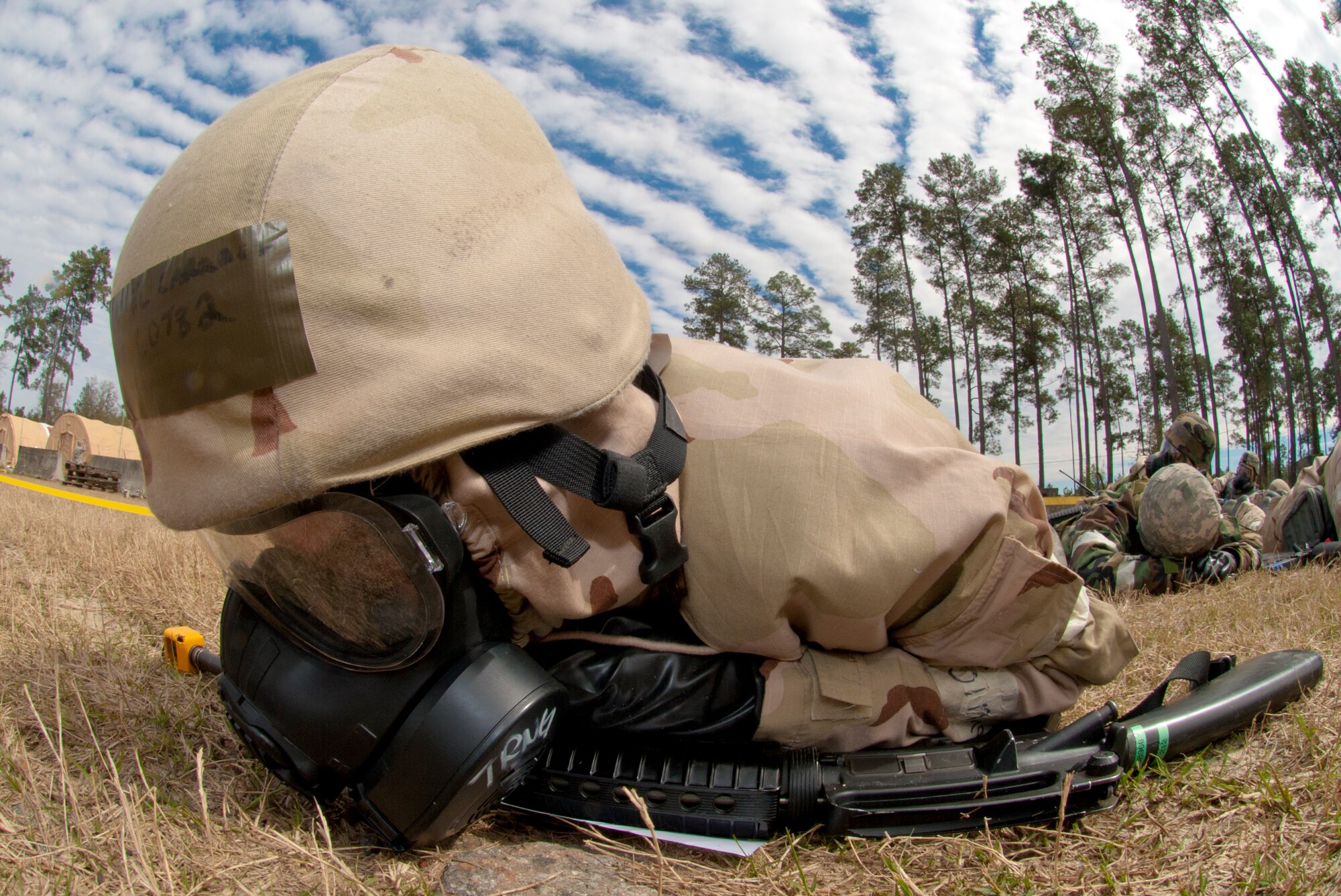 U.S. Air Force Airman 1st Class Daniel Carroll, 23d Civil Engineer Squadron command and control member, takes cover in a bunker during a phase II operational readiness exercise scenario Feb. 27, 2013, at Moody Air Force Base, Ga. During the scenario, the command and control tent caught fire, resulting in an evacuation. (U.S. Air Force Photo by Airman Paul Francis/Released)

