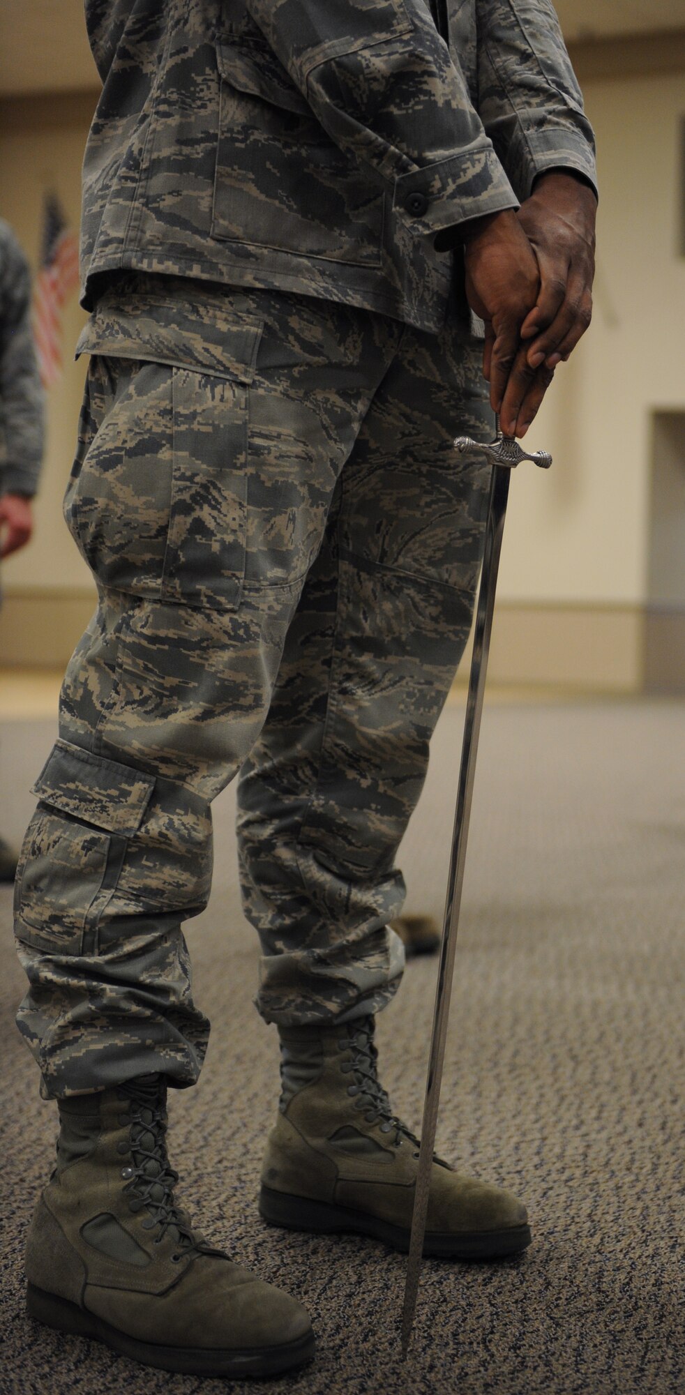 An Airman from the Barksdale Honor Guard Alpha Flight stands at ease during saber cordon practice on Barksdale Air Force Base, La., Feb. 28. Airmen walk under a saber cordon during promotion ceremonies to signify the transition of a junior Airman entering the NCO ranks and an NCO entering the senior NCO ranks. It is also used to recognize winners and nominees for awards. (U.S. Air Force photo/Airman 1st Class Benjamin Gonsier)
