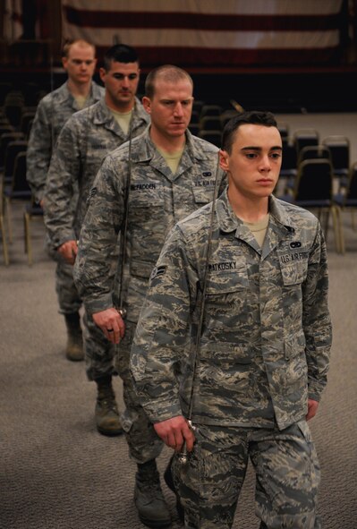 Airmen from the Barksdale Honor Guard Alpha Flight march in place during a saber cordon practice on Barksdale Air Force Base, La., Feb. 28. Honor Guard Airmen are constantly practicing ceremonial procedures to ensure maximum efficiency. (U.S. Air Force photo/Airman 1st Class Benjamin Gonsier)
