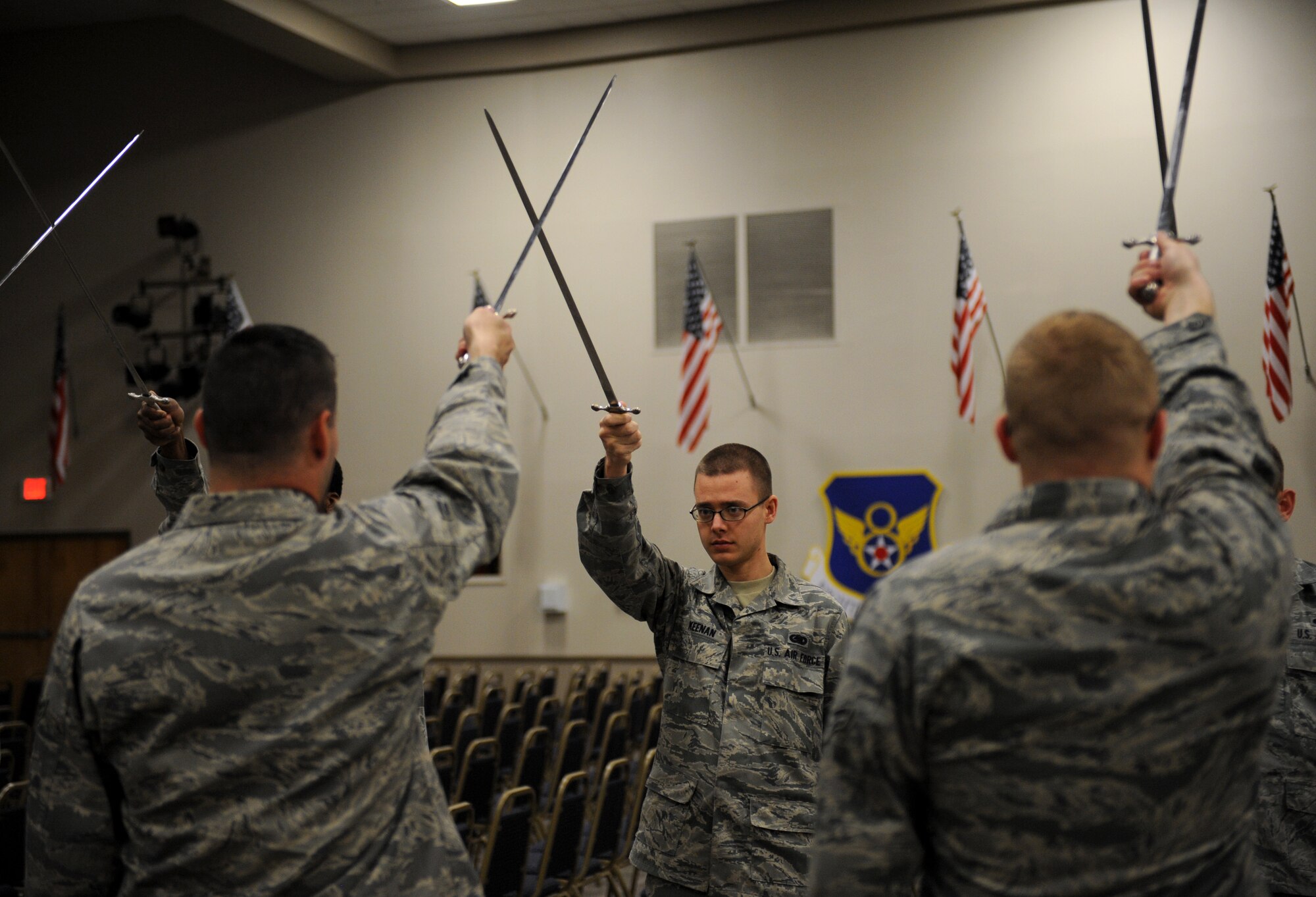 Airmen from the Barksdale Honor Guard Alpha Flight perform a saber cordon procedure on Barksdale Air Force Base, La., Feb. 28. Airmen walk under a saber cordon during promotion ceremonies to signify the transition of a junior Airman entering the NCO ranks and an NCO entering the senior NCO ranks. It is also used to recognize winners and nominees for awards. (U.S. Air Force photo/Airman 1st Class Benjamin Gonsier)
