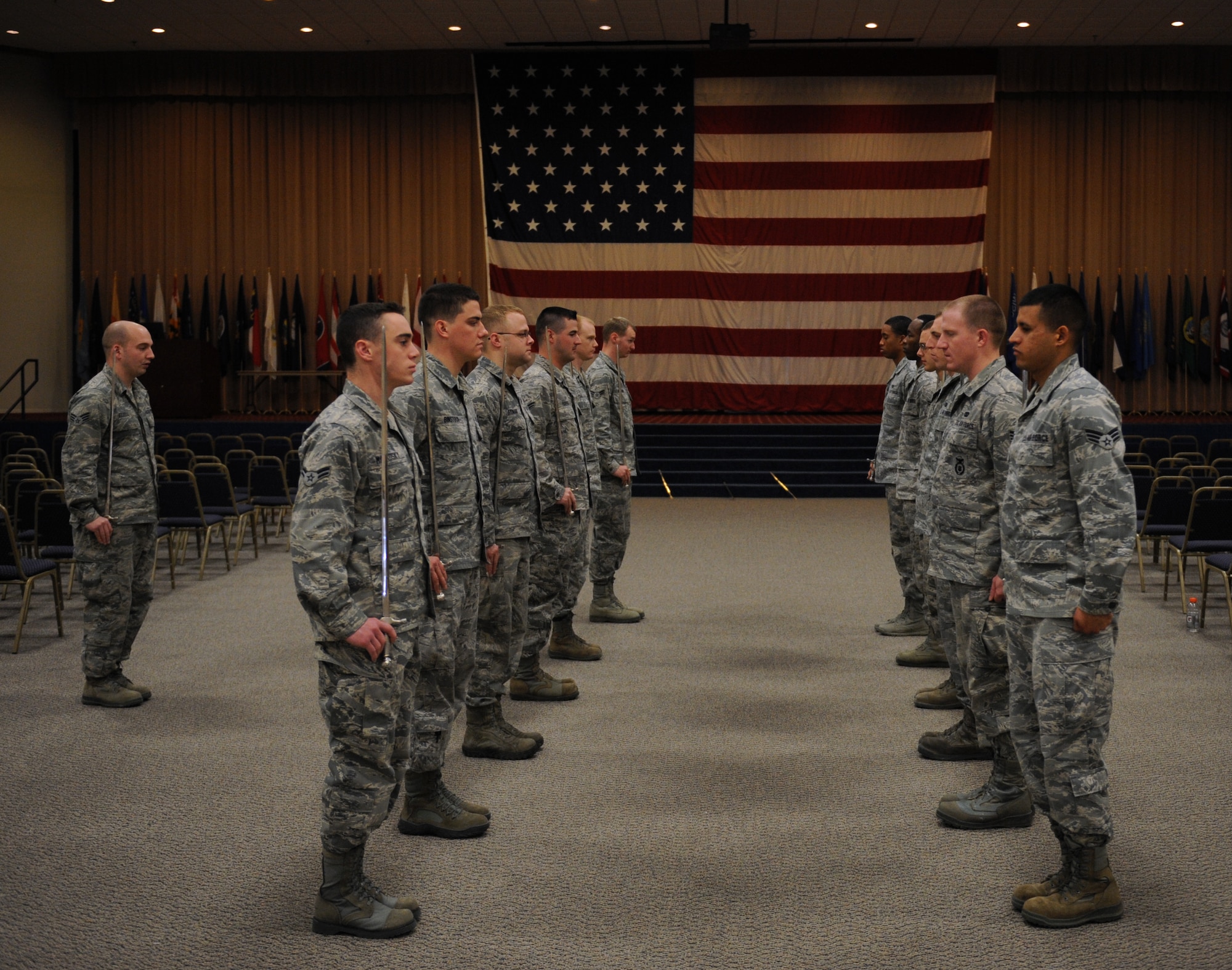 Airmen from the Barksdale Honor Guard Alpha Flight prepare to present arms during saber cordon practice on Barksdale Air Force Base, La., Feb. 28. Airmen walk under a saber cordon during promotion ceremonies to signify the transition of a junior Airman entering the NCO ranks and an NCO entering the senior NCO ranks. It is also used to recognize winners and nominees for awards. (U.S. Air Force photo/Airman 1st Class Benjamin Gonsier)
