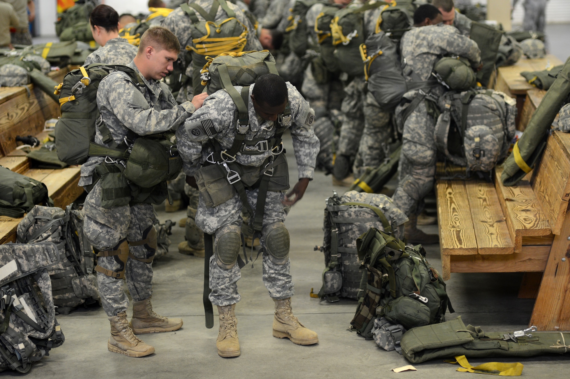 U.S. Army Pfc. Roel Martinez and Sgt. Isaac Kutting, 2nd Battalion, 504th Parachute Infantry Regiment, 1st Brigade Combat Team, 82nd Airborne Division, prepare equipment for a static line airdrop during Joint Operational Access Exercise (JOAX) 13-02, Feb. 25, 2013, at Fort Bragg, N.C. JOAX 13-02 is a combined exercise which enables U.S. and Canadian mobility aircrews to train with paratroopers from the U.S. Army's 82nd Airborne Division on projecting combat power in a denied environment. (U.S. Air Force photo by Tech. Sgt. Jason Robertson)