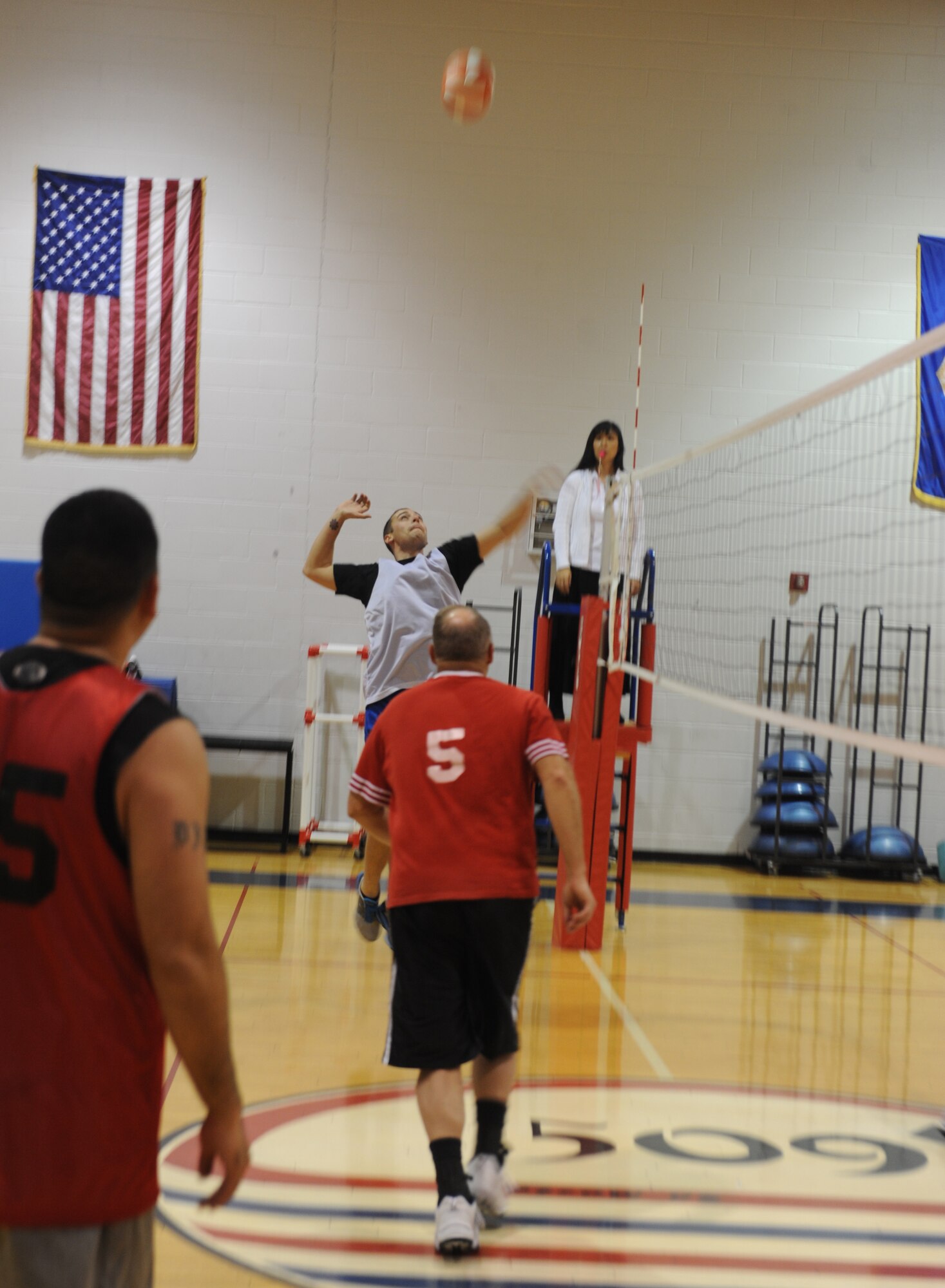 WHITEMAN AIR FORCE BASE, Mo. -- A member of the Civil Engineer-A team goes up to spike the ball against the Operations Support Squadron, Feb. 25. CE-A beat OSS in the first set, 25-16, on their way to a 2-0 match victory. (U.S. Air Force photo Airman 1st Class Bryan Crane)(Released)