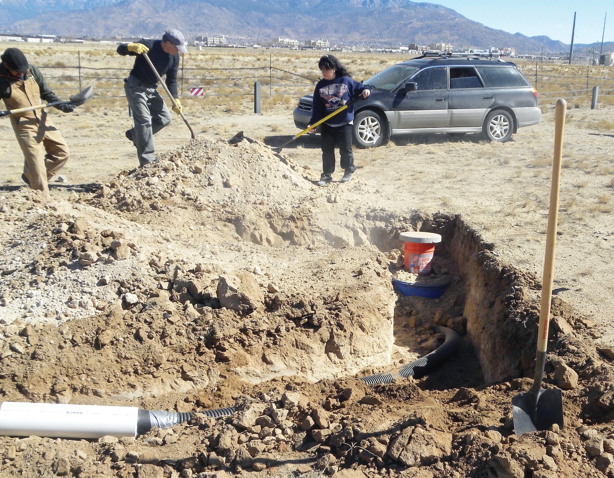 Members of the Kirtland AFB Environmental section bury an artificial burrow Feb. 26. 