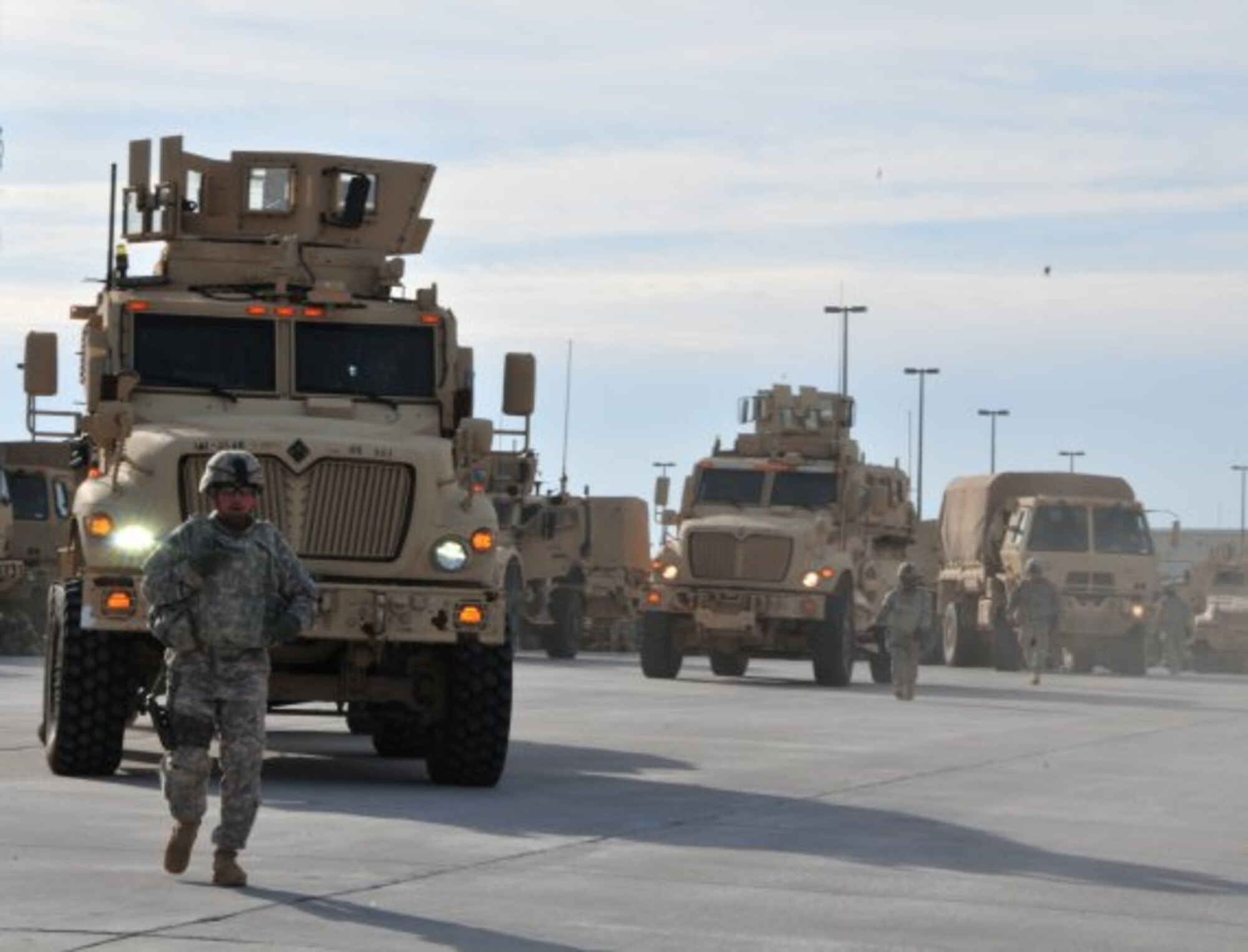 A Soldier from 2nd Brigade Combat Team, 1st Armored Division, ground guides during a convoy headed to White Sands Missile Range, N.M., to participate in the Network Integration Evaluation, or NIE, 13.1, which took place last fall. Soldiers from the brigade evaluate equipment for the Army in an operational environment in the NIEs that take place twice a year at Fort Bliss, Texas, and White Sands Missile Range, N.M. (U.S. Army photo by Lt. Col. Deanna Bague/Released)