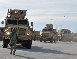 A Soldier from 2nd Brigade Combat Team, 1st Armored Division, ground guides during a convoy headed to White Sands Missile Range, N.M., to participate in the Network Integration Evaluation, or NIE, 13.1, which took place last fall. Soldiers from the brigade evaluate equipment for the Army in an operational environment in the NIEs that take place twice a year at Fort Bliss, Texas, and White Sands Missile Range, N.M. (U.S. Army photo by Lt. Col. Deanna Bague/Released)