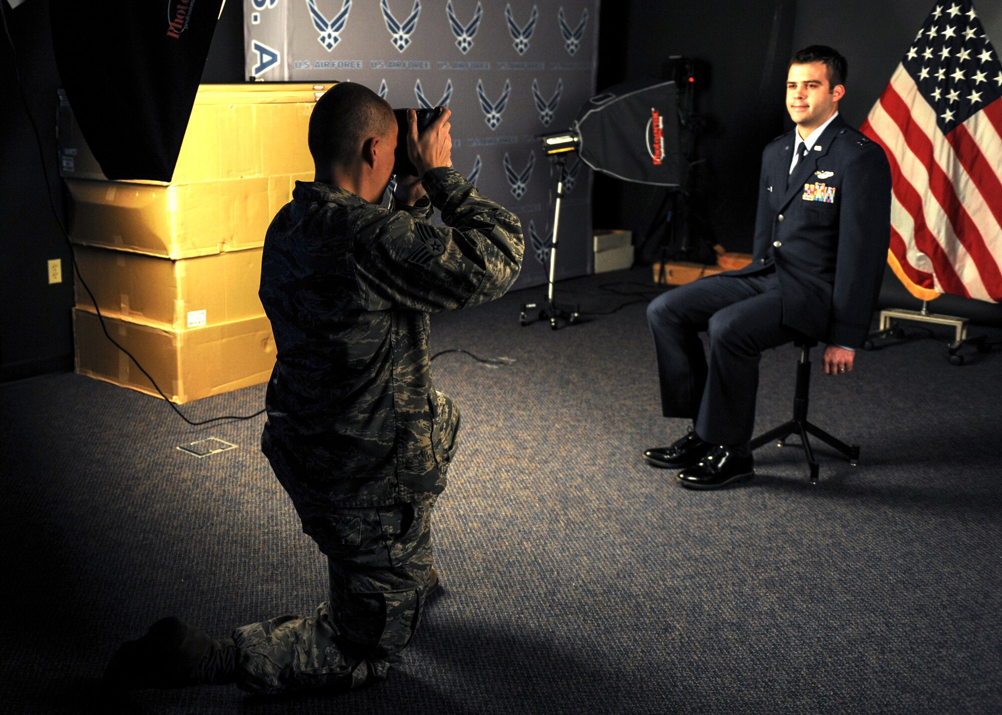 Senior Airman Rusty Frank, 19th Airlift Wing public affairs photojournalist, captures a studio portrait of Capt. Matthew Andrews, a 29th Weapons Squadron weapons instructor course cadre, Feb. 26, 2013, at Little Rock Air Force Base, Ark. The PA team supports studio photo sessions for official requests, such as award and special duty packages. (U.S. Air Force photo by Senior Airman Regina Agoha)