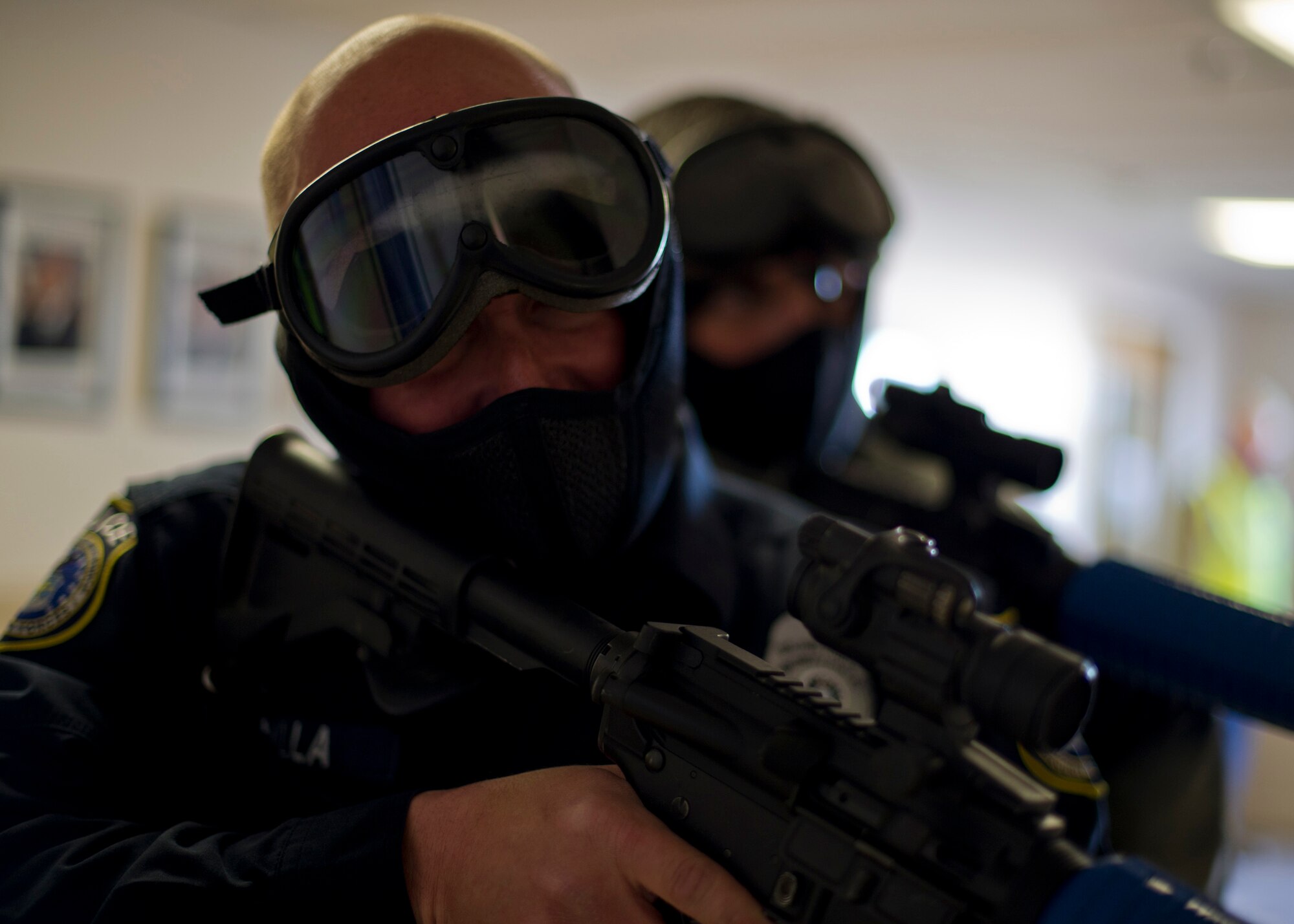 EXERCISE, EXERCISE, EXERCISE – Two 49th Security Forces Squadron members prepare to enter a room during an active shooter exercise at Holloman Air Force Base, N.M., Feb. 26. The active shooter exercise tested the threat response time and effectiveness of Holloman AFB’s first responders. After arriving on the scene, the combined efforts of the 49th Security Forces Squadron police took down the shooters. (U.S. Air Force photo by Senior Airman DeAndre Curtiss / Released)