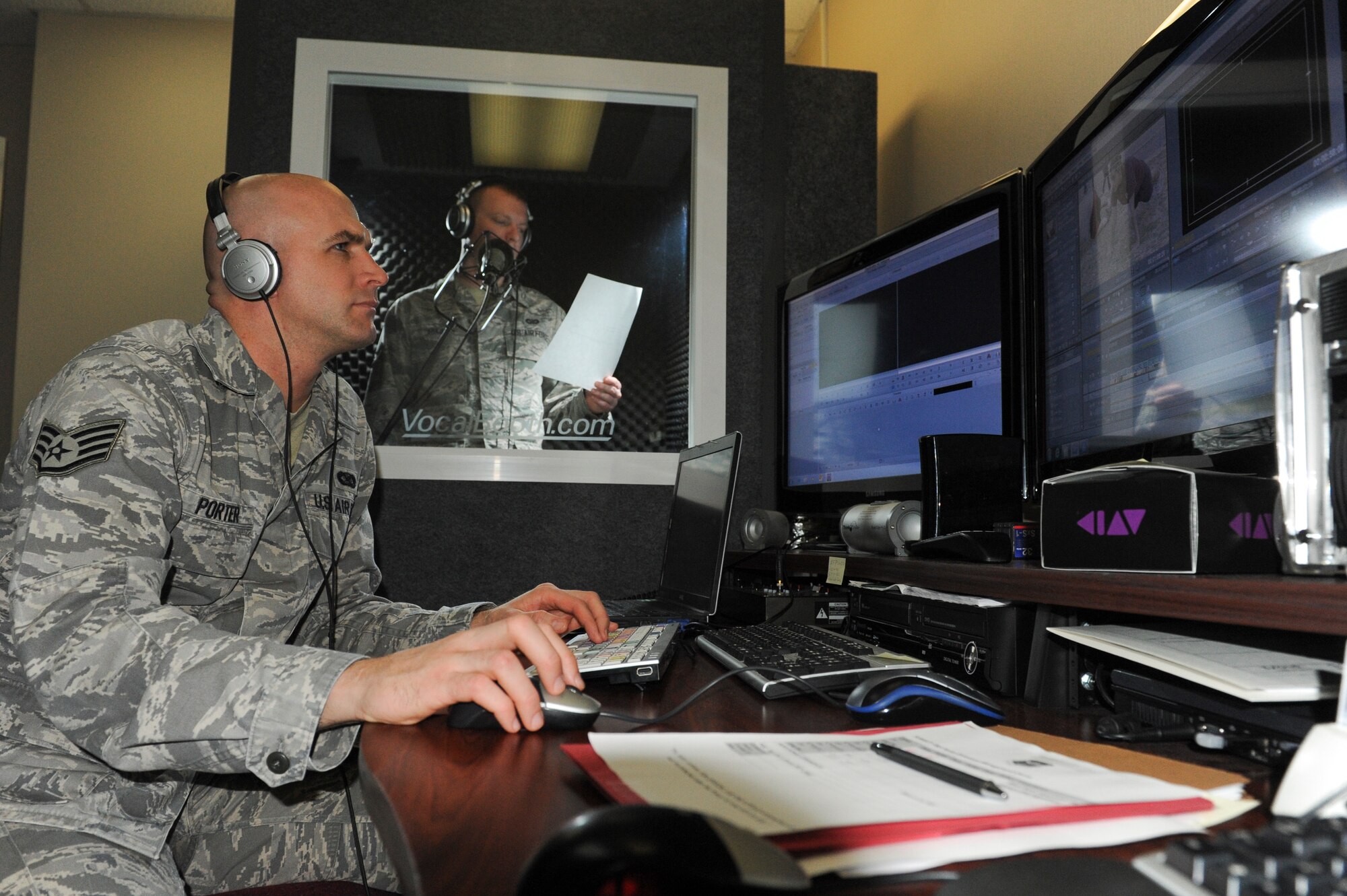 Staff Sgt. Jon Porter and Airman 1st Class Steven Adkins, 19th Airlift Wing public affairs broadcasters, utilize the soundproof vocal booth to record a voice-over Feb. 25, 2013, at Little Rock Air Force Base, Ark. Porter and Adkins create news stories and video projects for base units and agencies. (U.S. Air Force photo by Senior Airman Rusty Frank)