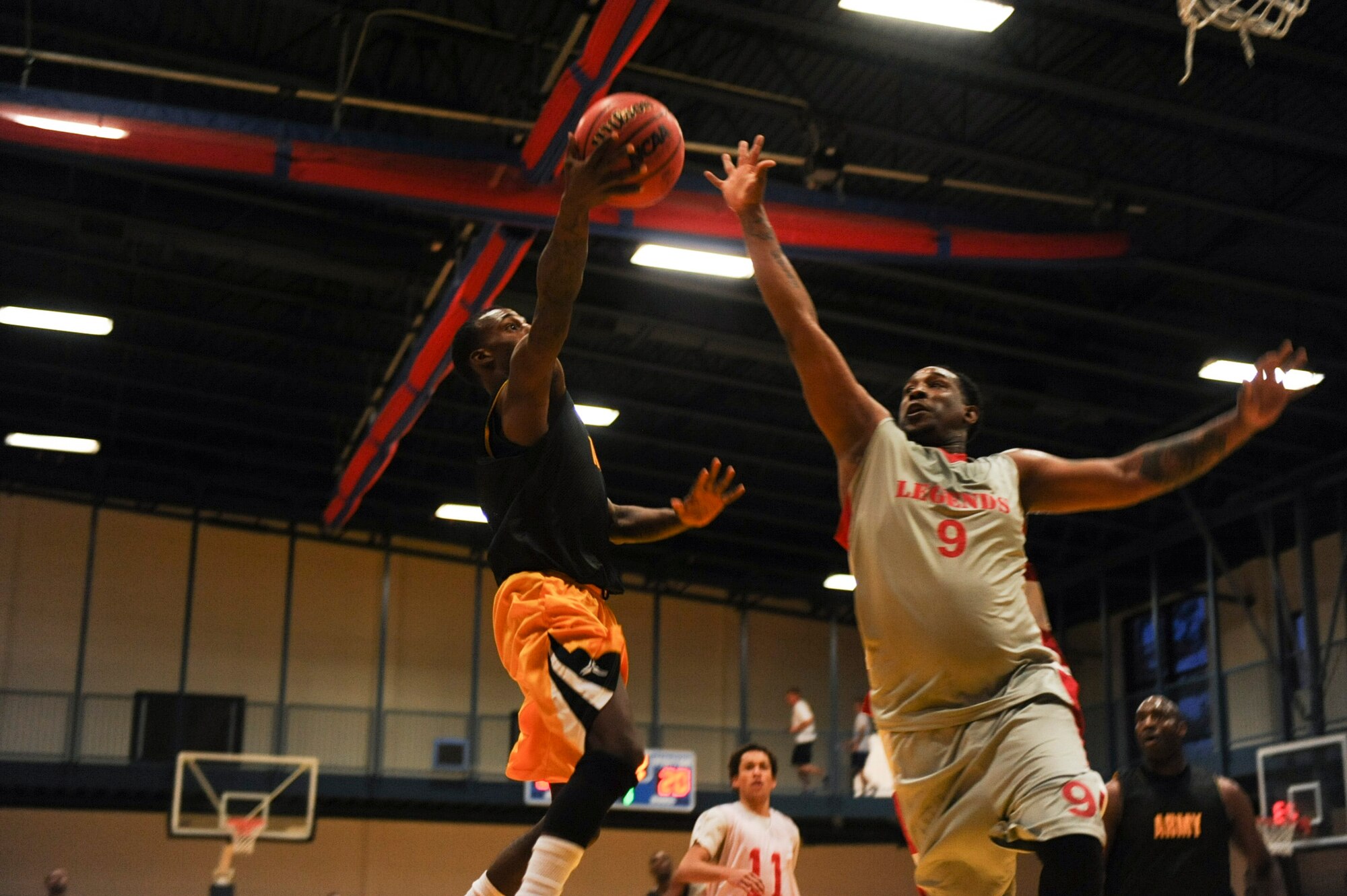 John Dismuke, point guard for Army intramural basketball team black, attempts a layup Feb. 26, 2013, at Little Rock Air Force Base, Ark. The black team, who led for most of the first half, lost 77-67. (U.S. Air Force photo by Airman 1st Class Cliffton Dolezal)