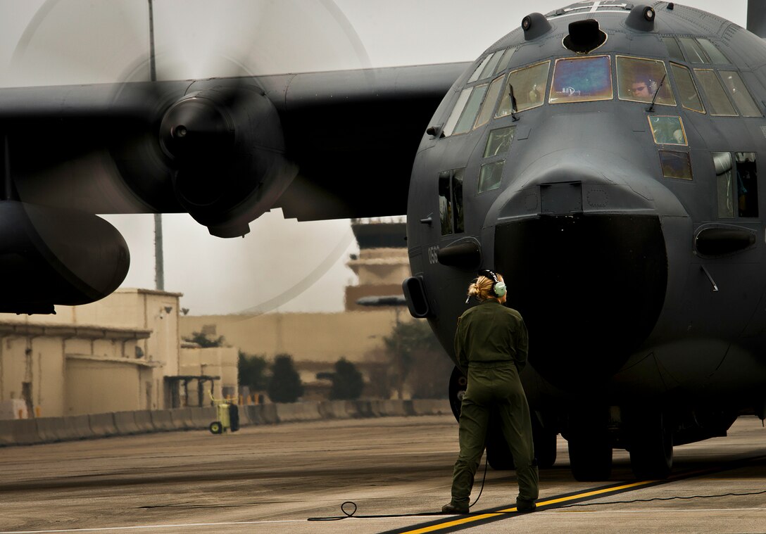 Senior Airman Rebecca Stinson, a loadmaster with the 711th Special Operations Squadron, talks with the aircrew during preflight checks before an MC-130E Combat Talon I sortie at Duke Field, Fla.  There are only five Talons left at the special operations reserve base.  The 919th has begun remissioning to the Aviation Foreign Internal Defense aircraft, the C-145 Skytruck.  (U.S. Air Force photo/Tech. Sgt. Samuel King Jr.)