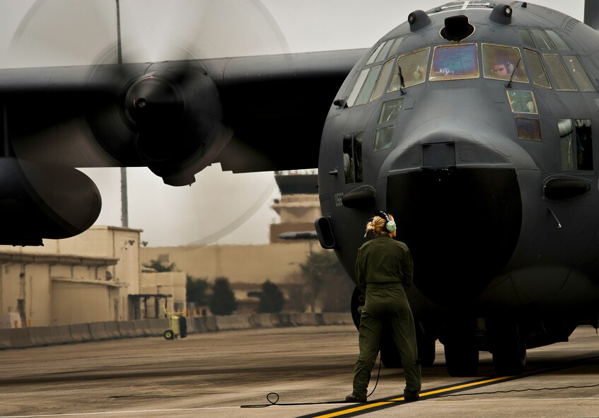 Senior Airman Rebecca Stinson, a loadmaster with the 711th Special Operations Squadron, talks with the aircrew during preflight checks before an MC-130E Combat Talon I sortie at Duke Field, Fla.  There are only five Talons left at the special operations reserve base.  The 919th has begun remissioning to the Aviation Foreign Internal Defense aircraft, the C-145 Skytruck.  (U.S. Air Force photo/Tech. Sgt. Samuel King Jr.)