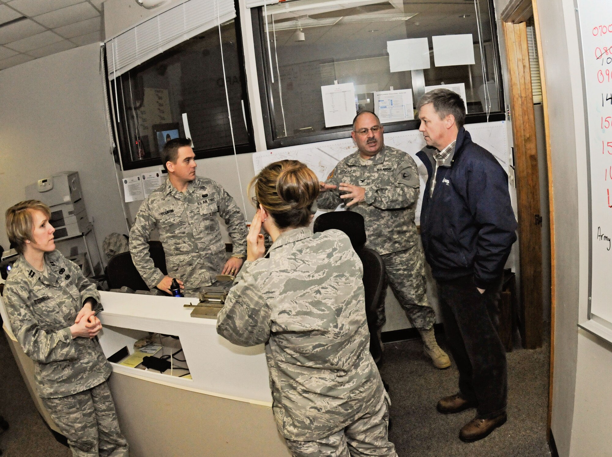 Craig Hallstrom, NStar president, speaks with members of the Emergency Operations Center, Otis Air National Guard Base, Mass., during a visit, Feb. 12. NStar Electric, a northeastern utility company, is temporarily basing a large assembly of utility workers and vehicles here in order to more effectively restore electricity to the citizens of Cape Cod due to effects of the brutal winter storm that hit the area, February 8 and 9. (National Guard photo by Tech. Sgt. Kerri Cole/Released)