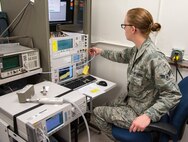 Airman 1st Class Melanie Mcelwain, 47th Flying Training Wing Precision Measurement Equipment Laboratory technician, works on a spectrum analyzer, used to check frequencies and amps, at the PMEL shop on Laughlin Air Force Base, Texas, Feb. 26, 2013. PMEL technicians work to ensure that measurement equipment ranging from scales at the base gym to aircraft gauges provide accurate information.  (U.S. Air Force photo/Senior Airman Nathan Maysonet)