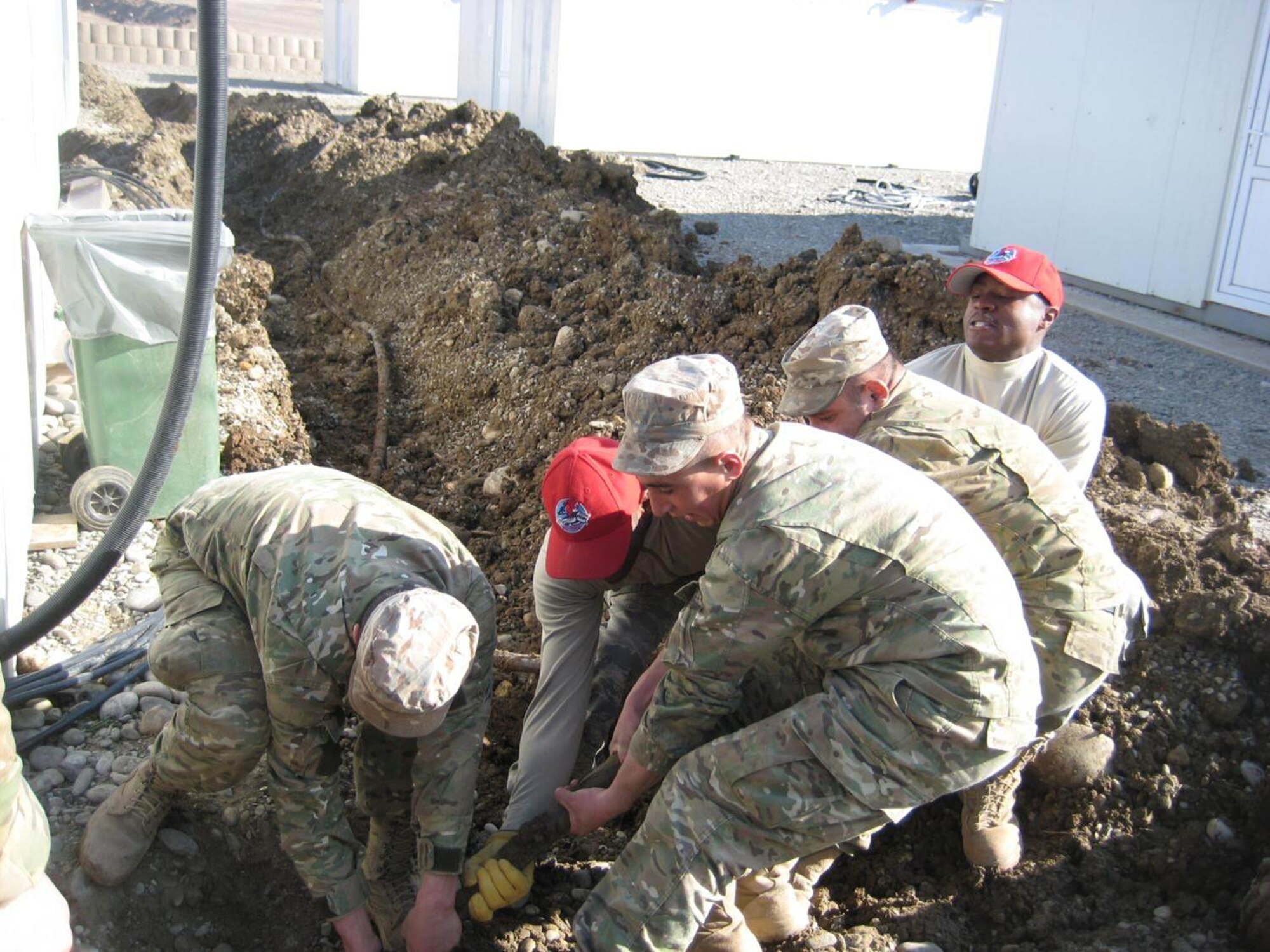 Tech. Sgt. Terry McNeil and Senior Airman Tony Rice, 819th Expeditionary RED
HORSE squadron,  lead Republic of Georgia conscripts in removing electrical
wire at the Vaziani South Training Area, Feb. 6, 2013. The RED HORSE
Squadron was tasked to deploy 200 personnel in support of European Command
from Nov. 1, 2012 to May 1, 2013.  As part of the deployment, the squadron
was tasked to complete camp improvements for Marine Forces Europe.  (U.S.
Air Force photo / Capt. Craig Poulin)
