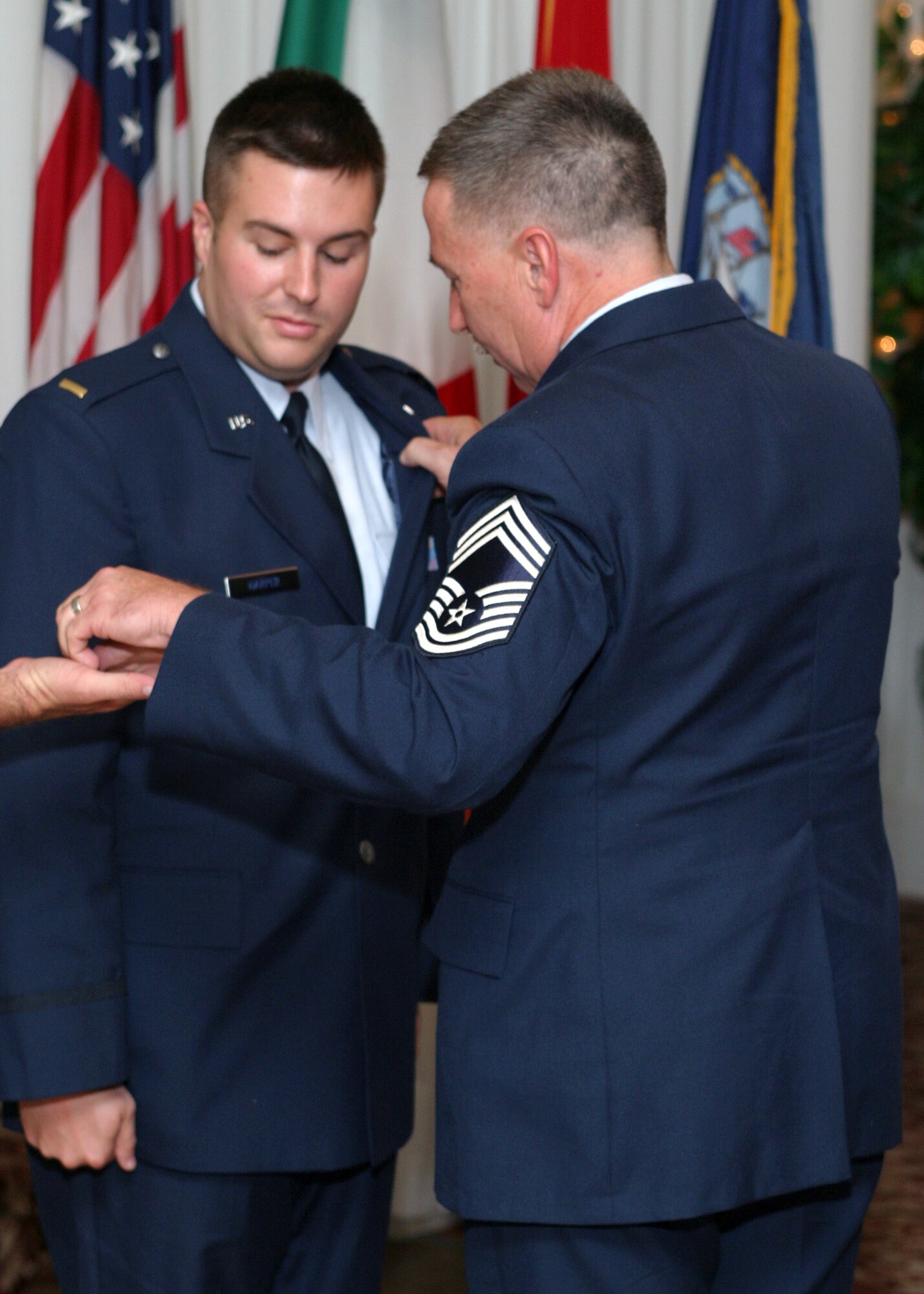 SOUTHWEST ASIA – Chief Master Sgt. Michael E. Harper pins on aviator wings on his son, then 2nd Lt. Michael J. Harper, during his son’s graduation from pilot training in Sept. 2006. Capt. Harper and his father are currently deployed together with the 746th Expeditionary Airlift Squadron. His son was later able to return the favor to his father by presiding over his last reenlistment. Both Airmen are Reservists deployed from the 908th Airlift Wing at Maxwell Air Force Base Ala. (Courtesy photo)