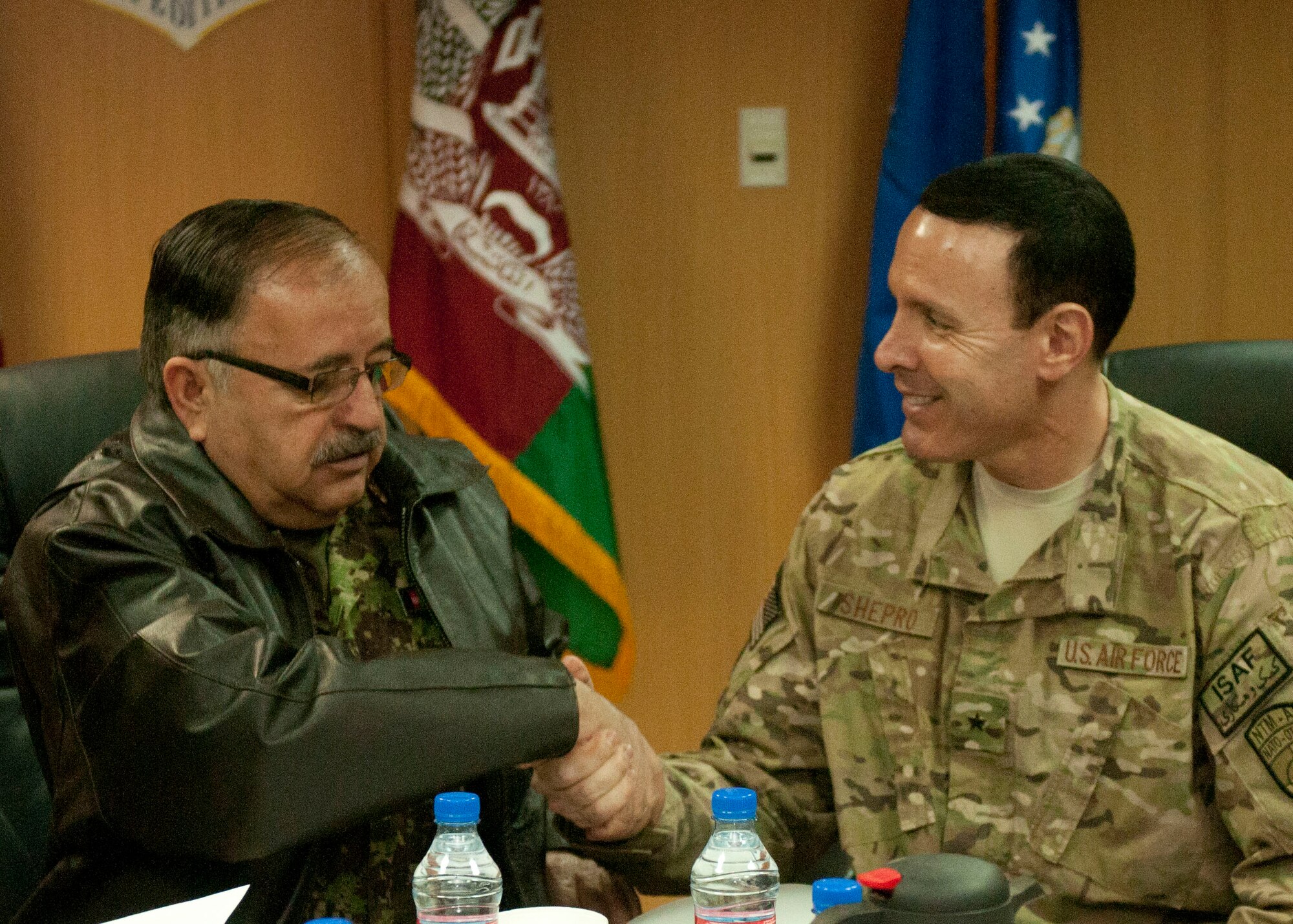 KABUL, AFGHANISTAN– In a ceremony held at the NATO Air Training Command-Afghanistan headquarters, Maj. Gen. Abdul Wahab Wardak, commander of the Afghan Air Force, along with Brig. Gen. Steve Shepro, NATC-A commander, shake hands after a historic signing ceremony for two documents, the Designated Operational Capability Statement and Unit Mission Decree Feb. 26, 2013. (U.S. Air Force photo/Tech. Sgt Joseph Prouse)
