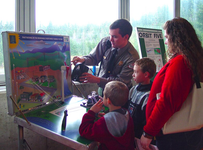 NRS Scharfe explains how hydropower and wind power work together in the Pacific Northwest, near Orbit Five. Families learned about hydropower at Bonneville Lock and Dam's Great Electrifying Event, which was held on Feb. 23, 2013.