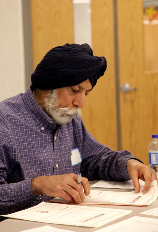 Middle East District mechanical engineer Iqbal Singh reviews and grades tests completed by the mathletes.