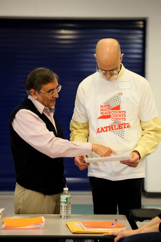 Transatlantic Division’s Ravi Seam, MATHCOUNTS regional coordinator, discusses a competition detail with the event’s emcee.