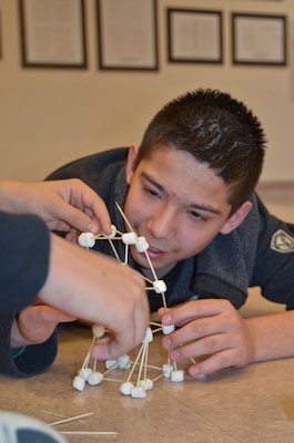 Students from Rogers Elementary School build a tower from toothpicks and mini-marshmallows.