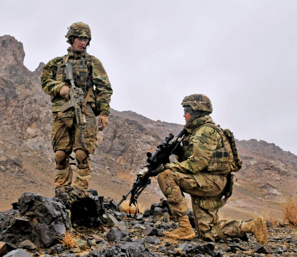 U.S. Army 1st Lt. James D. Whitler, left, walks along his unit's perimeter and checks on U.S. Army Spc. Alan L. Villalobos, right, at a remote Afghan Uniform Police checkpoint near Takhteh Pol in Kandahar province, Afghanistan, Feb. 26, 2013. Whitler, a platoon leader, and Villalobos, a infantryman, are assigned to the 2nd Infantry Division's Company B, 2nd Battalion, 23rd Infantry Regiment.