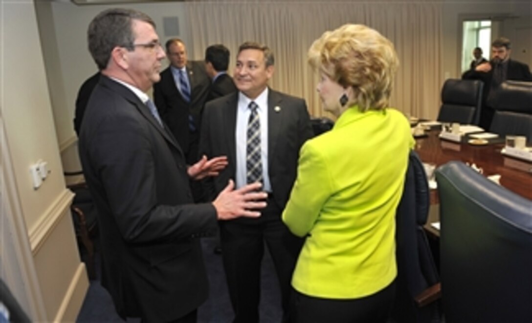 Deputy Secretary of Defense Ashton B. Carter, left, talks informally with the Governor of Guam Eddie Baza Calvo, center, and Guam’s Congresswoman Madeleine Z. Bordallo before they begin their meeting in the Pentagon on Feb. 27, 2013.  
