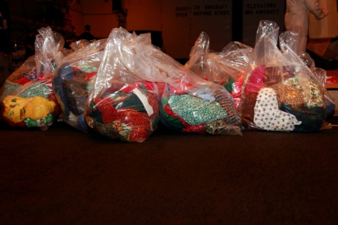 Stockings sit in the hangar bay of the USS Peleliu before being given to Marines and sailors of the 15th Marine Expeditionary Unit, Dec. 14.. The gifts were donated to the unit by Operation Santa, a charity group coordinated through the unit’s family readiness officer to provide stockings to deployed servicemembers. The 15th MEU is deployed as part of the Peleliu Amphibious Ready Group as a U.S. Central Command theater reserve force, providing support for maritime security operations and theater security cooperation efforts in the U.S. 5th Fleet area of responsibility. 