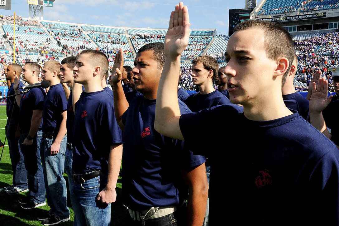 Poolees from Recruiting Station Jacksonville raise their right hands and repeat the Oath of Enlistment at a swearing-in ceremony held at EverBank Field before the Gator Bowl on January 1, 2013. Repeating of the oath and pledging their allegiance to their nation is a time honored tradition all service members perform as part of the induction process into the United States Armed Services.

The ceremony took place at the fifty yard-line of the stadium in front of  48,000 plus fans in attendance. (Official USMC photo by Pfc. John-Paul Imbody.)
