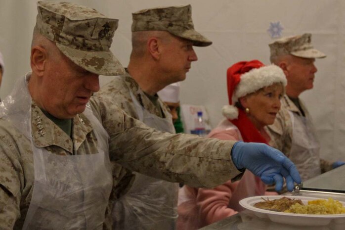 General James Mattis, left, commanding general, U.S. Central Command, serves Christmas dinner to servicemembers aboard Camp Leatherneck, Afghanistan, with Gen. John R. Allen, second from left, commanding general, International Security Assistance Force, Gen. James F. Amos, right, commandant of the Marine Corps and his wife Bonnie, Dec. 25, 2012. The leaders visited Marines serving in Afghanistan during the holiday season.