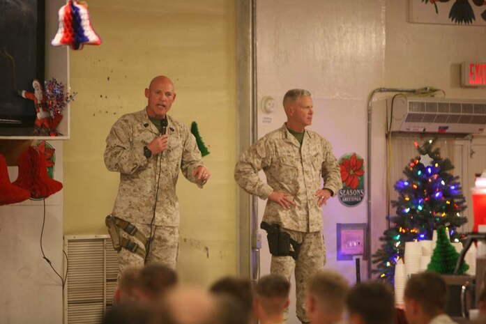 Sergeant Maj. of the Marine Corps Micheal P. Barrett speaks to Marines at Forward Operating Base Geronimo as Commandant of the Marine Corps Gen. James F. Amos looks on. The leadership traveled throughout Helmand province to wish servicemembers a Merry Christmas, Dec. 224 through Dec. 25, 2012.