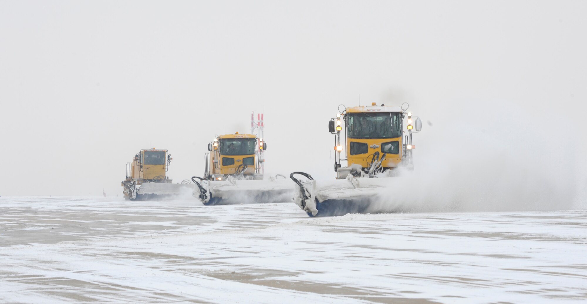 The 8th Civil Engineer Squadron snow removal team tackles flightline clean-up after a heavier than expected snowfall Dec. 28, 2012, at Kunsan Air Base, Republic of Korea. Their first priority is making sure the flightline is ready for use by F-16 Fighting Falcon pilots. (U.S. Air Force photo by Senior Airman Brigitte N. Brantley/Released)